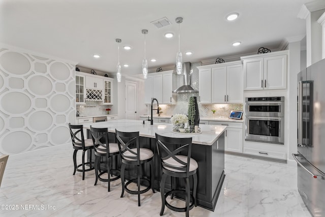 360 Rustic Mill Dr, Saint Augustine, FL 32092 - kitchen with appliances with stainless steel finishes, wall chimney exhaust hood, light marble finish flooring, light countertops, and decorative backsplash