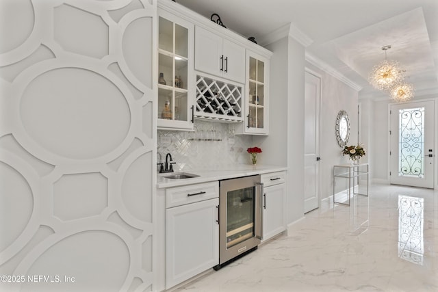 360 Rustic Mill Dr, Saint Augustine, FL 32092 - indoor wet bar featuring wine cooler, ornamental molding, a chandelier, tasteful backsplash, and light marble finish floors