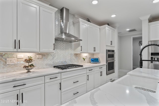 360 Rustic Mill Dr, Saint Augustine, FL 32092 - kitchen featuring wall chimney exhaust hood, appliances with stainless steel finishes, white cabinets, tasteful backsplash, and recessed lighting