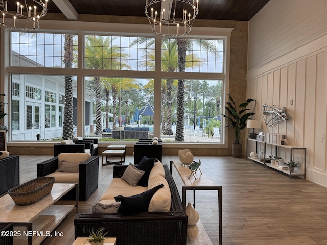 223 Creek Pebble Dr, Ponte Vedra, FL 32081 - living room featuring a chandelier, wood ceiling, wood finished floors, and a towering ceiling