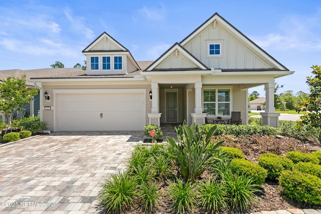 223 Creek Pebble Dr, Ponte Vedra, FL 32081 - view of front of house with board and batten siding, covered porch, decorative driveway, and a garage