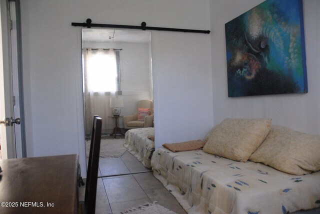 123 Arlington Way, Ormond Beach, FL 32176 - bedroom with a barn door and light tile patterned floors