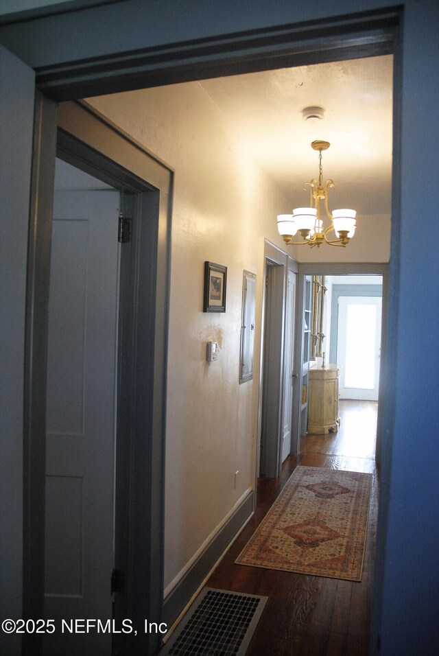 123 Arlington Way, Ormond Beach, FL 32176 - corridor featuring a chandelier, wood finished floors, and baseboards