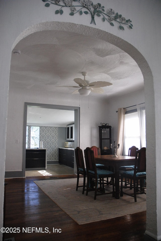 123 Arlington Way, Ormond Beach, FL 32176 - dining room featuring wood finished floors, arched walkways, and a ceiling fan