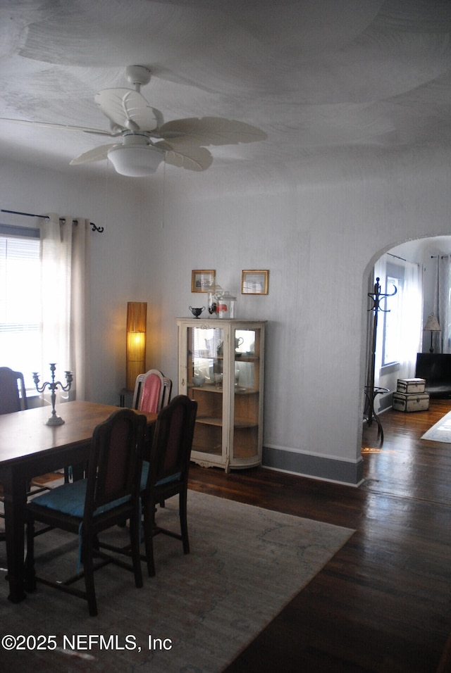 123 Arlington Way, Ormond Beach, FL 32176 - dining space with arched walkways, wood finished floors, ceiling fan, and baseboards