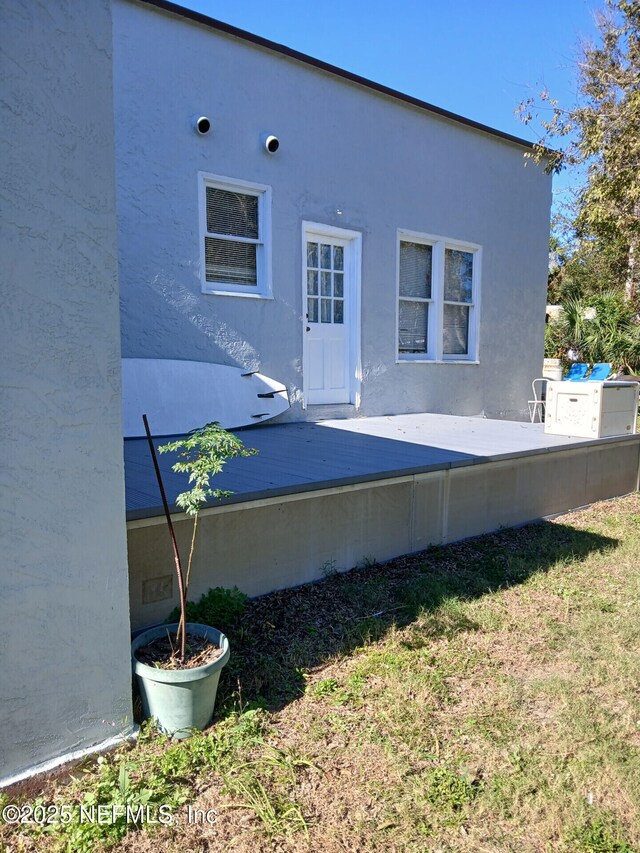 123 Arlington Way, Ormond Beach, FL 32176 - back of property with stucco siding and a yard