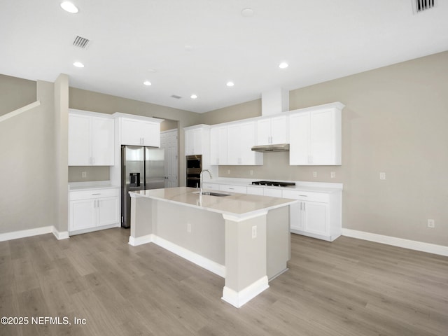 471 Rum Runner Way, Saint Johns, FL 32259 - kitchen with appliances with stainless steel finishes, a center island with sink, light wood finished floors, a sink, and recessed lighting