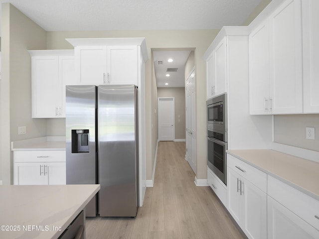 471 Rum Runner Way, Saint Johns, FL 32259 - kitchen with appliances with stainless steel finishes, light countertops, light wood finished floors, white cabinetry, and recessed lighting