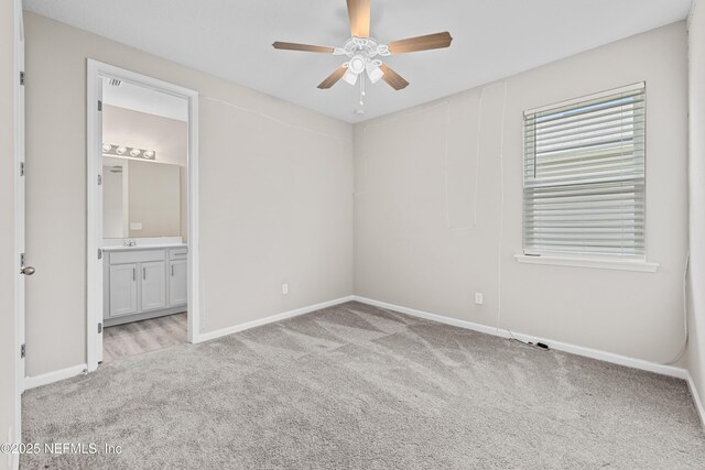 618 Honeycomb Trl, Saint Augustine, FL 32095 - unfurnished bedroom with carpet, baseboards, connected bathroom, and a ceiling fan