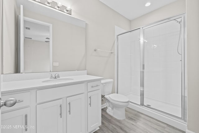 618 Honeycomb Trl, Saint Augustine, FL 32095 - bathroom with wood finished floors, toilet, tiled shower, and vanity