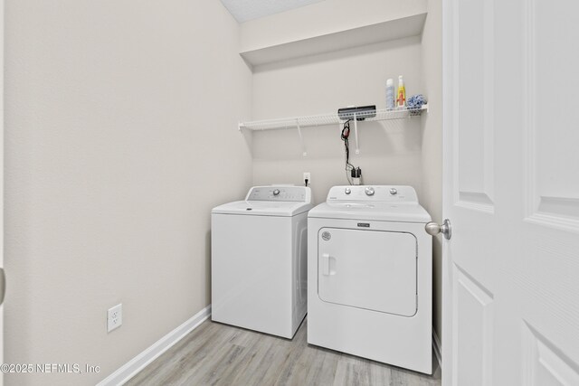 618 Honeycomb Trl, Saint Augustine, FL 32095 - washroom with washing machine and clothes dryer, light wood-style floors, and baseboards