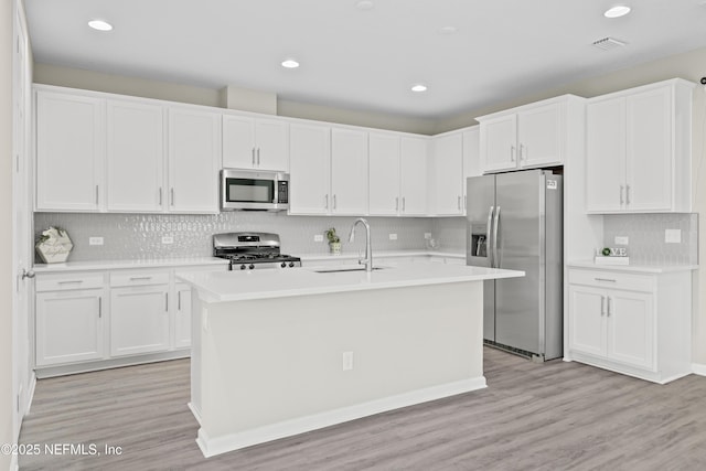 618 Honeycomb Trl, Saint Augustine, FL 32095 - kitchen featuring stainless steel appliances, a sink, light countertops, decorative backsplash, and white cabinets