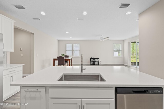 618 Honeycomb Trl, Saint Augustine, FL 32095 - kitchen with stainless steel dishwasher, a sink, light countertops, recessed lighting, and white cabinetry