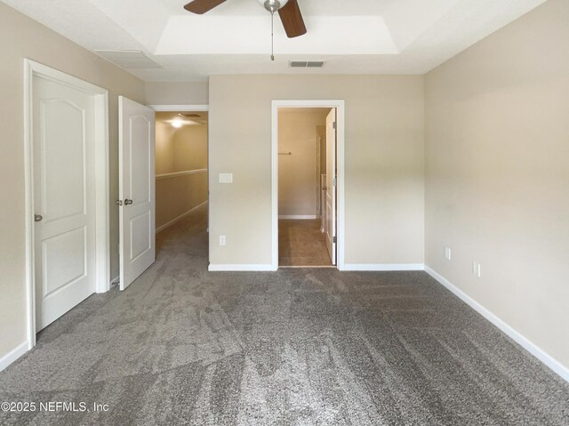 unfurnished bedroom featuring carpet, baseboards, ceiling fan, and connected bathroom