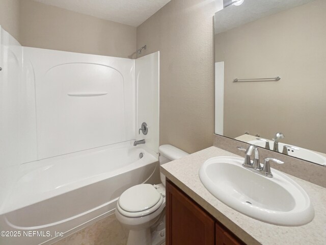 bathroom with toilet, shower / washtub combination, and vanity