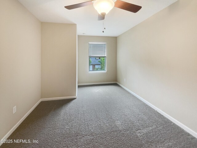 empty room with carpet, baseboards, and a ceiling fan