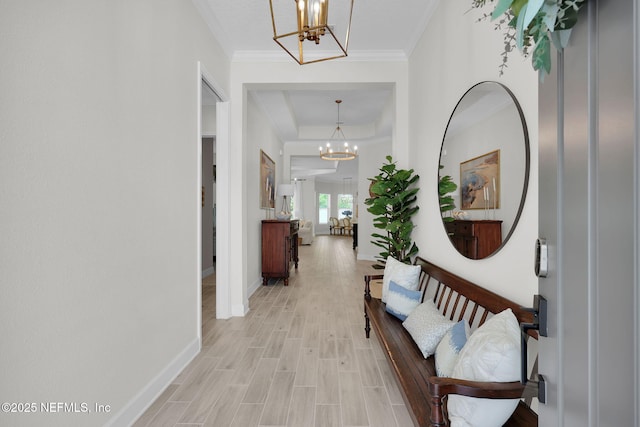 111 Bucktail Ave, Ponte Vedra, FL 32081 - corridor featuring a chandelier, baseboards, light wood-style floors, a raised ceiling, and crown molding