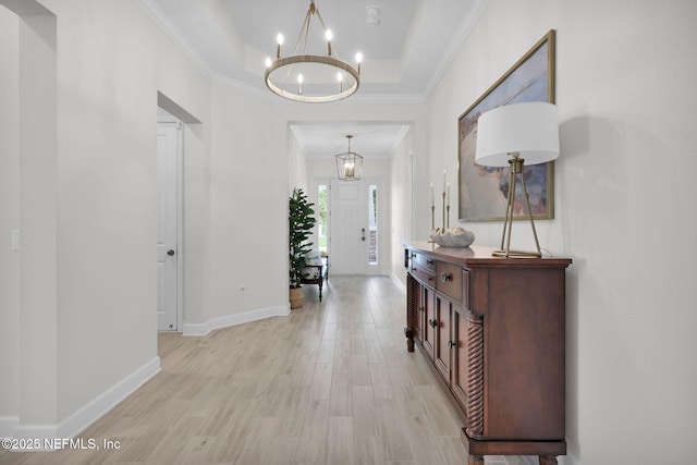 111 Bucktail Ave, Ponte Vedra, FL 32081 - foyer entrance featuring a chandelier, light wood-style floors, a tray ceiling, baseboards, and ornamental molding