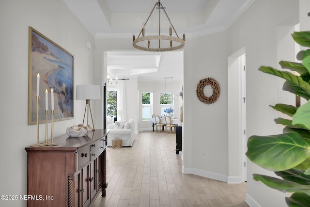 111 Bucktail Ave, Ponte Vedra, FL 32081 - hall with a chandelier, light wood-style flooring, baseboards, a tray ceiling, and ornamental molding
