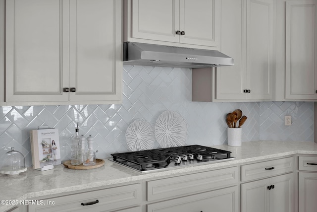 111 Bucktail Ave, Ponte Vedra, FL 32081 - kitchen featuring under cabinet range hood, stainless steel gas stovetop, backsplash, and white cabinetry