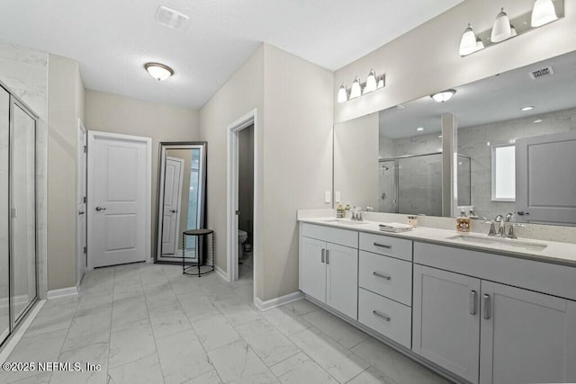 full bath featuring marble look tile flooring, a shower stall, baseboards, and toilet