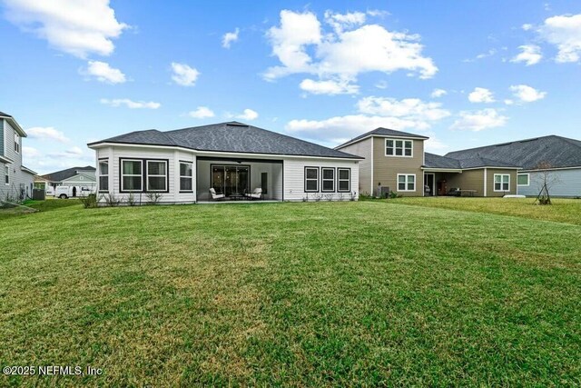 back of house with a yard and a patio area