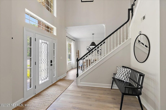 12768 Cattail Pond Cir S, Jacksonville, FL 32224 - foyer featuring stairs, healthy amount of natural light, wood finished floors, baseboards, and a towering ceiling