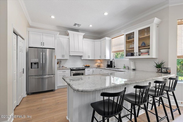 12768 Cattail Pond Cir S, Jacksonville, FL 32224 - kitchen featuring appliances with stainless steel finishes, healthy amount of natural light, a sink, a peninsula, and crown molding