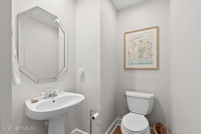 12768 Cattail Pond Cir S, Jacksonville, FL 32224 - bathroom with toilet, baseboards, and a sink