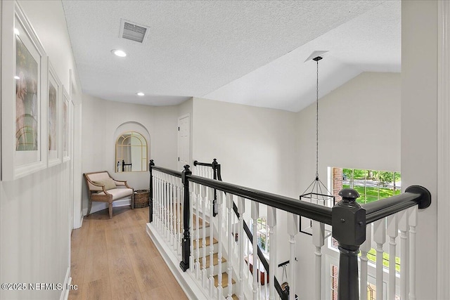 12768 Cattail Pond Cir S, Jacksonville, FL 32224 - hallway featuring an upstairs landing, light wood-style floors, a textured ceiling, recessed lighting, and vaulted ceiling