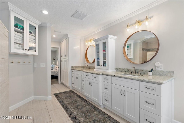 12768 Cattail Pond Cir S, Jacksonville, FL 32224 - bathroom featuring double vanity, a textured ceiling, ornamental molding, ensuite bathroom, and tile patterned floors