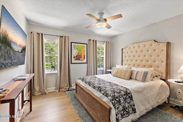 12768 Cattail Pond Cir S, Jacksonville, FL 32224 - bedroom featuring light wood-type flooring, a textured ceiling, baseboards, and a ceiling fan