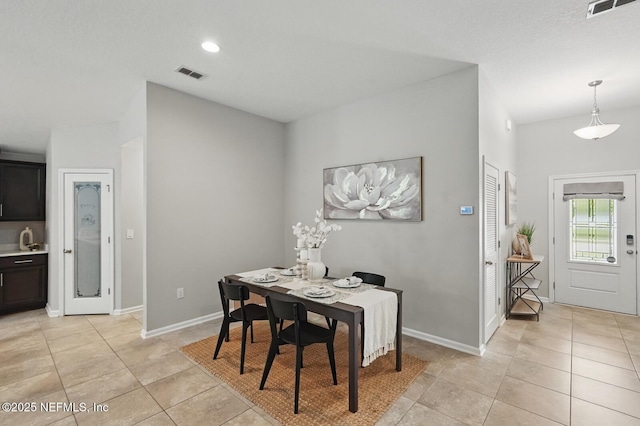 481 Fox Water Trl, Saint Augustine, FL 32086 - dining area with light tile patterned flooring, baseboards, and vaulted ceiling