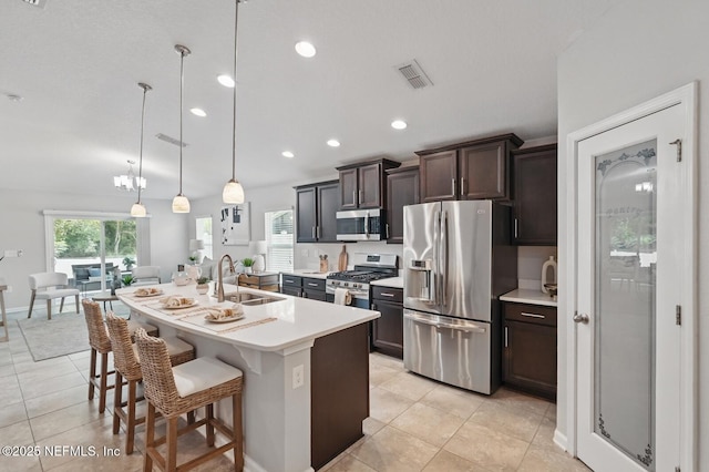 481 Fox Water Trl, Saint Augustine, FL 32086 - kitchen with appliances with stainless steel finishes, a sink, light tile patterned flooring, light countertops, and dark brown cabinetry