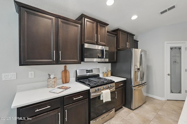 481 Fox Water Trl, Saint Augustine, FL 32086 - kitchen featuring stainless steel appliances, dark brown cabinetry, light countertops, light tile patterned floors, and baseboards