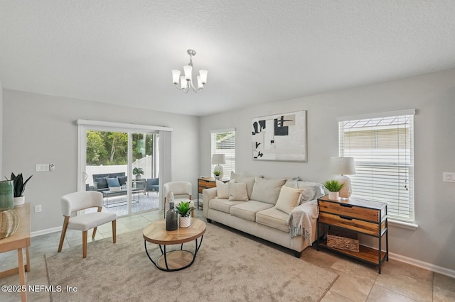 481 Fox Water Trl, Saint Augustine, FL 32086 - living area featuring a chandelier, baseboards, and a textured ceiling