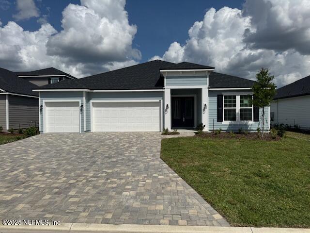317 Archstone Way, Saint Augustine, FL 32092 - view of front of property featuring a garage, decorative driveway, and a front lawn