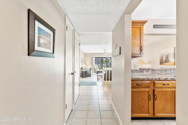 8550 A1A S Unit 14151, Saint Augustine, FL 32080 - hallway featuring light tile patterned floors, a textured ceiling, and baseboards