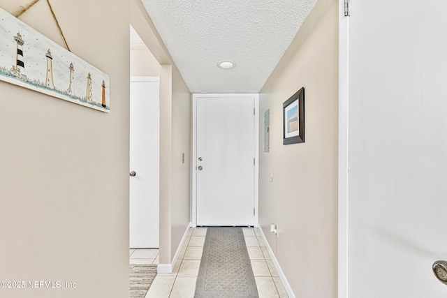 8550 A1A S Unit 14151, Saint Augustine, FL 32080 - doorway to outside with a textured ceiling, light tile patterned flooring, and baseboards