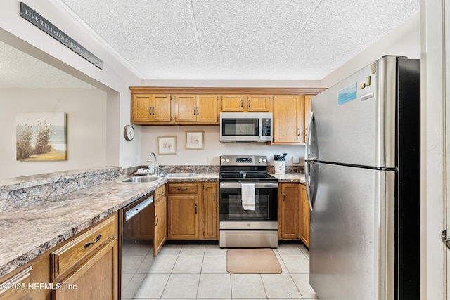 8550 A1A S Unit 14151, Saint Augustine, FL 32080 - kitchen featuring appliances with stainless steel finishes, a sink, brown cabinets, a textured ceiling, and light countertops