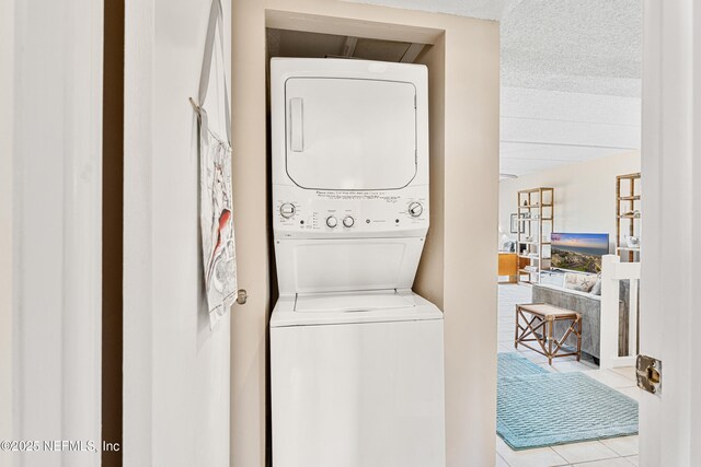 8550 A1A S Unit 14151, Saint Augustine, FL 32080 - laundry area with stacked washer / dryer, tile patterned floors, and a textured ceiling