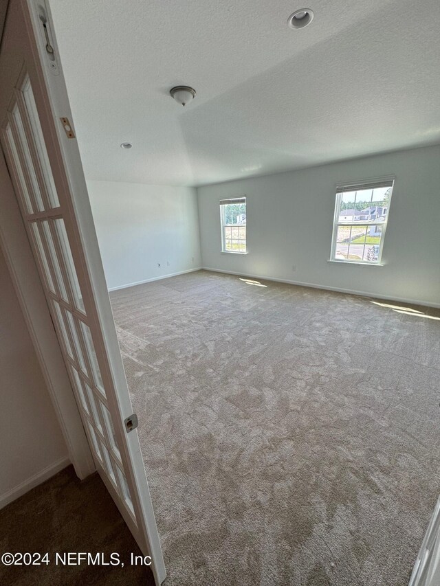 150 Iris Landing Dr, Saint Augustine, FL 32092 - empty room featuring carpet flooring, baseboards, and a textured ceiling