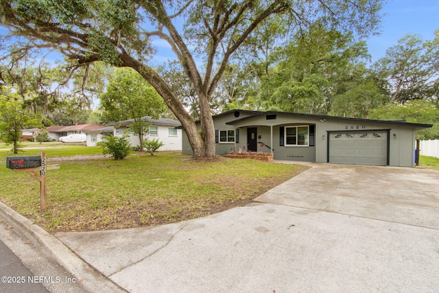 2520 Elbow Rd, Orange Park, FL 32073 - single story home featuring a garage, concrete driveway, and a front lawn