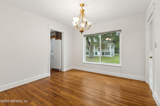 2520 Elbow Rd, Orange Park, FL 32073 - unfurnished dining area featuring a chandelier, wood finished floors, and baseboards
