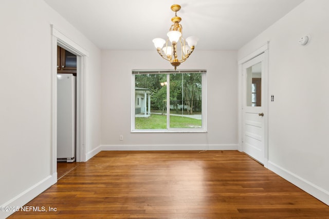 2520 Elbow Rd, Orange Park, FL 32073 - unfurnished dining area featuring a chandelier, wood finished floors, and baseboards