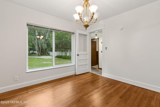 2520 Elbow Rd, Orange Park, FL 32073 - empty room featuring baseboards, a chandelier, and wood finished floors