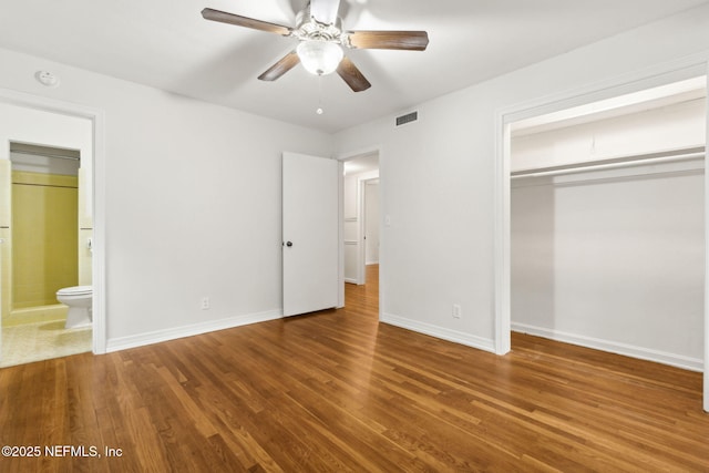2520 Elbow Rd, Orange Park, FL 32073 - unfurnished bedroom with wood finished floors, a closet, baseboards, and ensuite bathroom