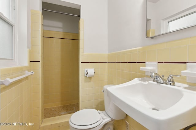 2520 Elbow Rd, Orange Park, FL 32073 - bathroom with a stall shower, tile walls, a sink, toilet, and wainscoting