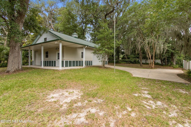 2520 Elbow Rd, Orange Park, FL 32073 - exterior space with a yard, driveway, ceiling fan, metal roof, and a chimney