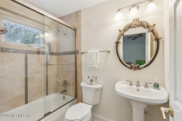 3429 Sea Marsh Rd, Fernandina Beach, FL 32034 - bathroom featuring shower / bath combination with glass door, toilet, ceiling fan, and baseboards